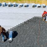 roof replacement repair worker hands installing shingles