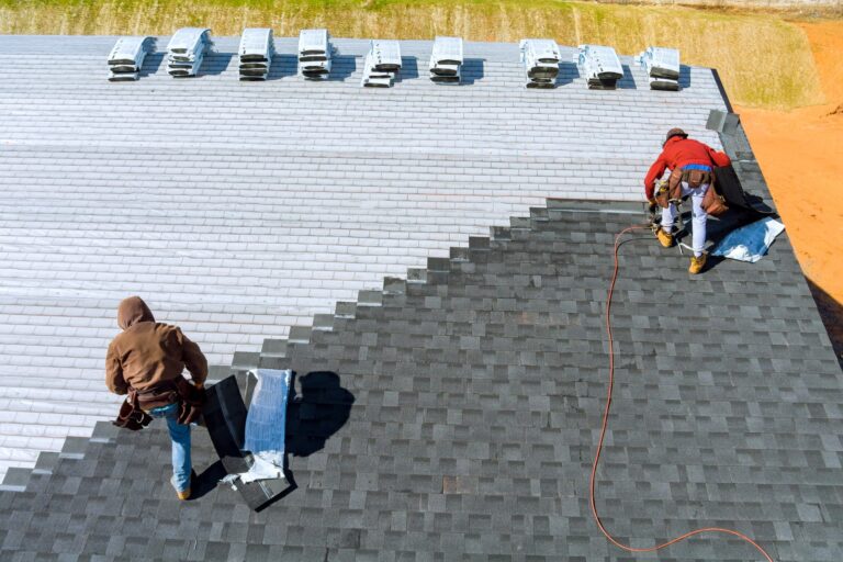 roof replacement repair worker hands installing shingles