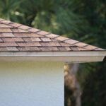 roofline corner closeup of house roof top covered with asphalt shingles 1920